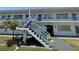 Charming two-story apartment complex with well-maintained grounds, stairs to second level, and a tropical palm tree at 2011 58Th N Ave # 20, St Petersburg, FL 33714