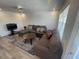 Bright living room featuring a comfortable sectional sofa, a modern TV setup, and a large window for natural light at 2011 58Th N Ave # 20, St Petersburg, FL 33714