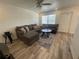 Inviting living room with a large sectional sofa, decorative pillows, and a stylish ceiling fan creating a cozy atmosphere at 2011 58Th N Ave # 20, St Petersburg, FL 33714