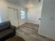 Cozy living room with wood laminate flooring, modern chandelier, and neutral walls offering a versatile living space at 2011 58Th N Ave # 20, St Petersburg, FL 33714
