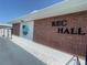 Exterior of Rec Hall featuring brick walls, signage, and a well-maintained walkway, ideal for community gatherings at 2011 58Th N Ave # 20, St Petersburg, FL 33714