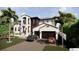 Elegant two-story home featuring a lush lawn, covered entry, and a convenient two-car garage at 2019 Illinois Ne Ave, St Petersburg, FL 33703