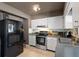 A kitchen featuring white cabinetry, stainless steel appliances, and neutral-toned countertops for a simple look at 2048 64Th S Ave, St Petersburg, FL 33712