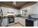 Efficient kitchen with white cabinets, black appliances, and ample counter space for cooking and meal preparation at 2048 64Th S Ave, St Petersburg, FL 33712