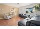 Cozy living room featuring hardwood floors, comfortable seating, and a bright window for natural light at 2048 64Th S Ave, St Petersburg, FL 33712