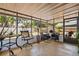 Enclosed sunroom with comfortable seating, views of the backyard, and a peaceful space for relaxation at 2048 64Th S Ave, St Petersburg, FL 33712