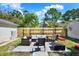 Backyard patio features an outdoor seating area, grass area, and a wooden fence at 2107 W Carmen St, Tampa, FL 33606