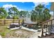 Spacious backyard with a wooden fence, patio seating, and a large palm tree at 2107 W Carmen St, Tampa, FL 33606