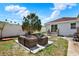 Backyard featuring patio furniture, brick pavers, a barbecue grill, and a palm tree at 2107 W Carmen St, Tampa, FL 33606