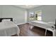 Shared bedroom with pale green walls, bright windows, and two comfortable beds at 2107 W Carmen St, Tampa, FL 33606