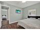 Inviting bedroom with a mounted TV, bright window, and connected rooms at 2107 W Carmen St, Tampa, FL 33606