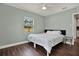 Relaxing bedroom with pale green walls, hardwood floors, and a scenic view through the window at 2107 W Carmen St, Tampa, FL 33606