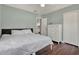 Cozy bedroom with pale green walls, dark wood floors, and a white dresser for ample storage at 2107 W Carmen St, Tampa, FL 33606