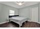 Calm bedroom with pale green walls, dark wood floors, and a bright window at 2107 W Carmen St, Tampa, FL 33606