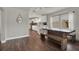 Bright dining room with a modern table, wooden bench, and view into the white kitchen at 2107 W Carmen St, Tampa, FL 33606