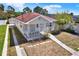 Single-story home featuring a covered porch, a driveway and landscaping at 2107 W Carmen St, Tampa, FL 33606