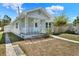 View of a single-story home featuring a covered porch, and fresh landscaping at 2107 W Carmen St, Tampa, FL 33606