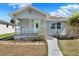 Charming single-story home with a cozy front porch and a beautifully landscaped front yard at 2107 W Carmen St, Tampa, FL 33606