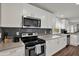 Modern kitchen with stainless steel appliances, gray backsplash, and lots of counter space at 2107 W Carmen St, Tampa, FL 33606