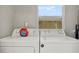 Laundry area showcasing modern washer and dryer set under a bright window at 2107 W Carmen St, Tampa, FL 33606