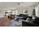 Open-concept living area with dark hardwood floors and lots of natural light at 2107 W Carmen St, Tampa, FL 33606