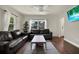 Bright living room with modern ceiling fan, large window, and dark hardwood floors at 2107 W Carmen St, Tampa, FL 33606