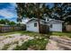 Exterior of a charming white home with gravel yard and a fenced in backyard at 2443 2Nd S Ave, St Petersburg, FL 33712