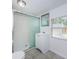 Bathroom with a tiled walk-in shower, light colored vanity, and a window for natural light at 2443 2Nd S Ave, St Petersburg, FL 33712