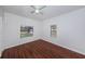 Bedroom with hardwood floors, white walls, windows and a ceiling fan at 2443 2Nd S Ave, St Petersburg, FL 33712