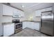 Bright kitchen featuring stainless steel appliances, white cabinetry, and stone countertops at 2443 2Nd S Ave, St Petersburg, FL 33712