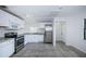 Bright kitchen featuring stainless steel appliances, white cabinetry, and stone countertops at 2443 2Nd S Ave, St Petersburg, FL 33712
