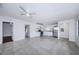Open-concept living area with tile floors, leading into a bright kitchen with white cabinetry at 2443 2Nd S Ave, St Petersburg, FL 33712