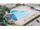 Aerial view of a heart-shaped community pool with surrounding lounge chairs at 2468 Florentine Way # 26, Clearwater, FL 33763