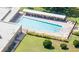 Aerial view of a rectangular community pool surrounded by patio and green space at 2468 Florentine Way # 26, Clearwater, FL 33763