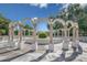 View of white decorative arches in a circle over a well manicured shrub at 2468 Florentine Way # 26, Clearwater, FL 33763