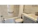 Remodeled bathroom featuring a gray vanity, a bathtub, and a shower with white marble-patterned tile surround at 2468 Florentine Way # 26, Clearwater, FL 33763