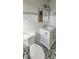 Bright bathroom featuring elegant white marble-like tile, modern fixtures, and stylish hexagon floor tiles at 2468 Florentine Way # 26, Clearwater, FL 33763