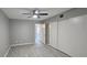 Neutral bedroom with large closet, ceiling fan, and light gray wood laminate flooring at 2468 Florentine Way # 26, Clearwater, FL 33763
