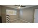 Cozy bedroom with a ceiling fan, neutral walls, and laminate flooring for a modern touch at 2468 Florentine Way # 26, Clearwater, FL 33763