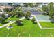 Aerial view of the community park with walking paths, picnic tables, parking, and shuffleboard courts at 2468 Florentine Way # 26, Clearwater, FL 33763