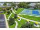 Aerial view of the community park with walking paths, mature trees, picnic tables, and parking lot at 2468 Florentine Way # 26, Clearwater, FL 33763