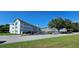 Exterior view of the multi-story condo building with well-maintained landscaping and ample parking at 2468 Florentine Way # 26, Clearwater, FL 33763