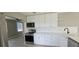Bright kitchen with stainless steel appliances, white cabinets, and quartz countertops at 2468 Florentine Way # 26, Clearwater, FL 33763