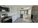Modern kitchen with stainless steel appliances, white cabinets, and a bright dining area at 2468 Florentine Way # 26, Clearwater, FL 33763
