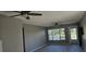 Living room features a ceiling fan, window, and neutral colors at 2468 Florentine Way # 26, Clearwater, FL 33763