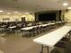 Spacious meeting room featuring rows of tables with chairs and a stage for presentations at 2468 Florentine Way # 26, Clearwater, FL 33763