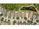 An aerial view displays neatly arranged homes, green spaces and a serene pond at 25332 Lexington Oaks Blvd, Wesley Chapel, FL 33544