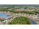 Aerial of the neighborhood showcasing homes nestled in trees near a picturesque lake at 25332 Lexington Oaks Blvd, Wesley Chapel, FL 33544