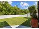Private fenced backyard with green grass and landscaping at 25332 Lexington Oaks Blvd, Wesley Chapel, FL 33544