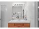 Bright bathroom featuring a wooden vanity with a white countertop and decorative accents at 25332 Lexington Oaks Blvd, Wesley Chapel, FL 33544
